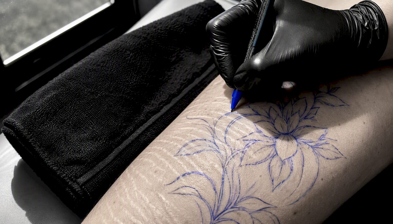 Temporary tattoo design sketched over stretch marks