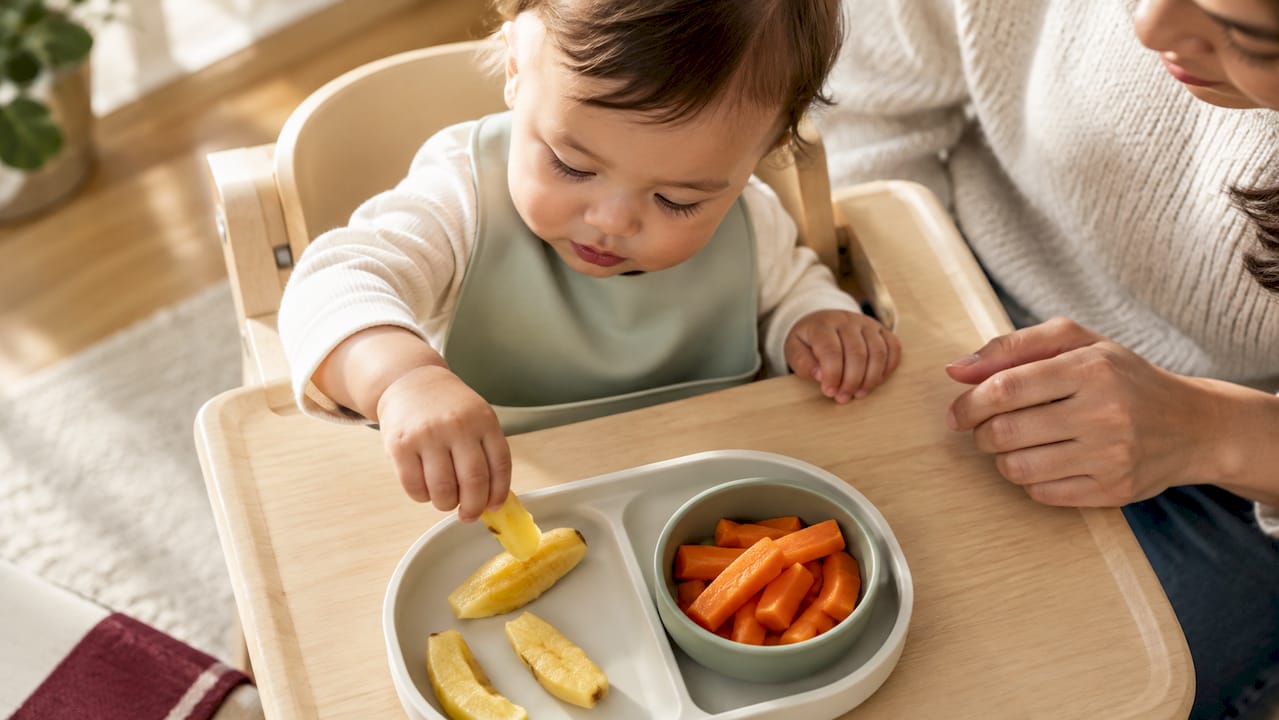 Baby practicing pincer grasp with soft foods