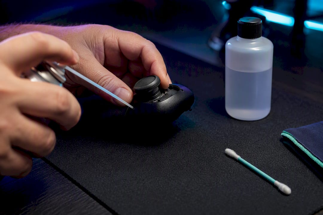 Cleaning dust from an analog stick base