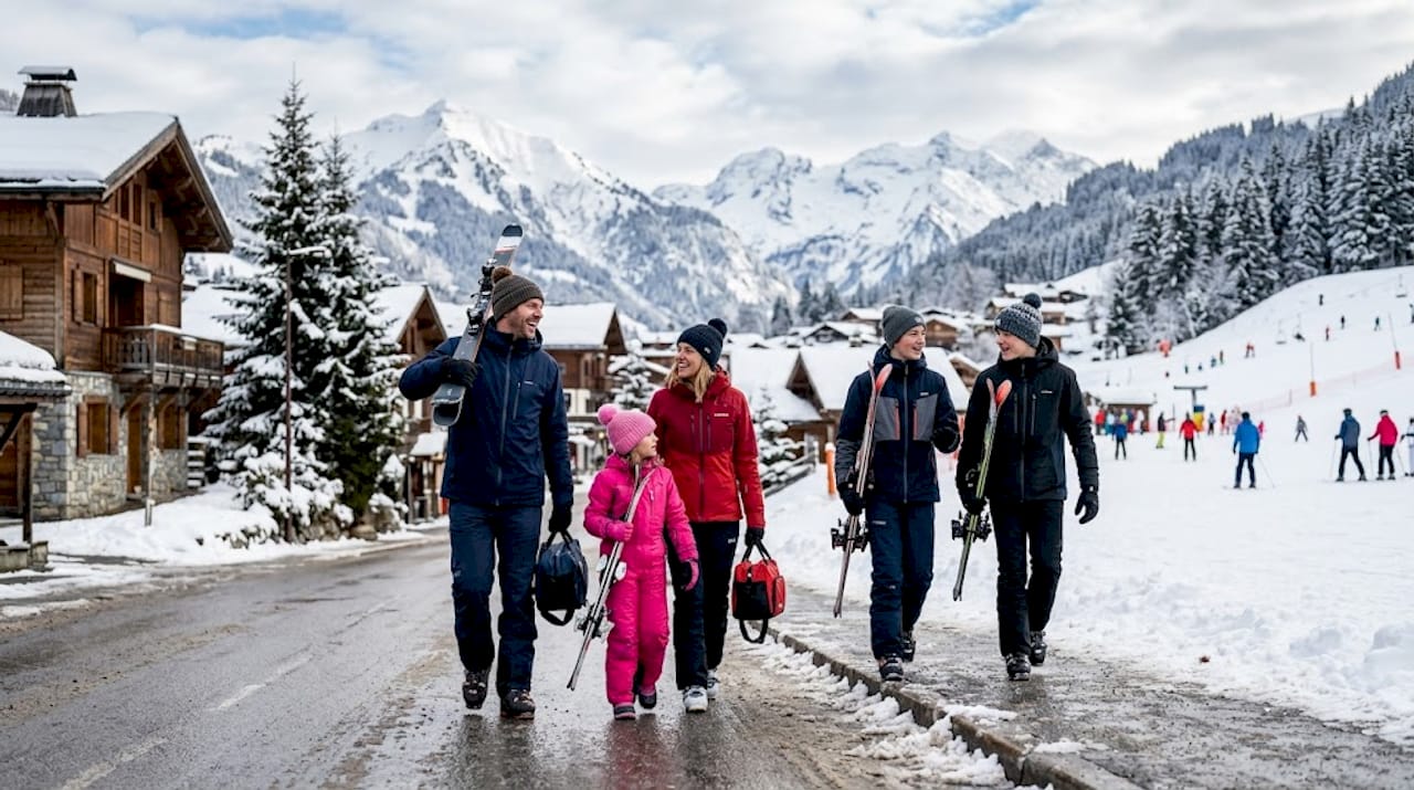 Family loading minivan in snowy Les Gets village