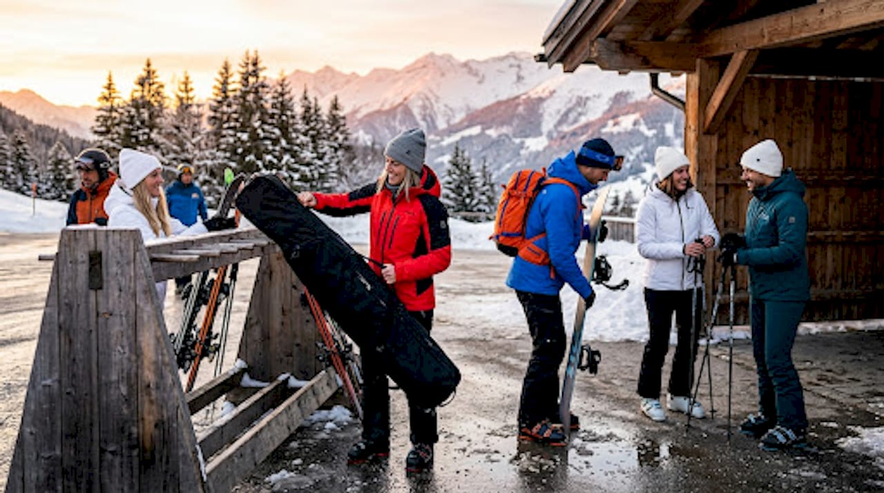 Shuttle bus loading passengers and ski gear