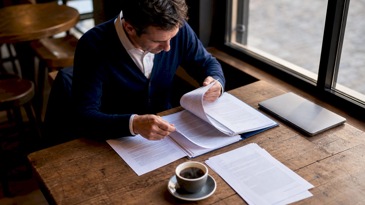 Policy analyst reviewing legalization documents at desk