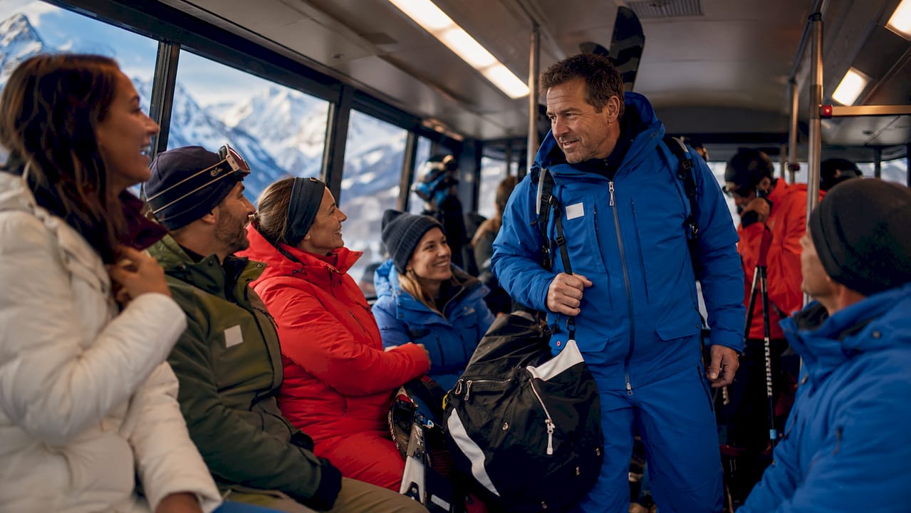Busy shared ski shuttle loading bags at Geneva Airport
