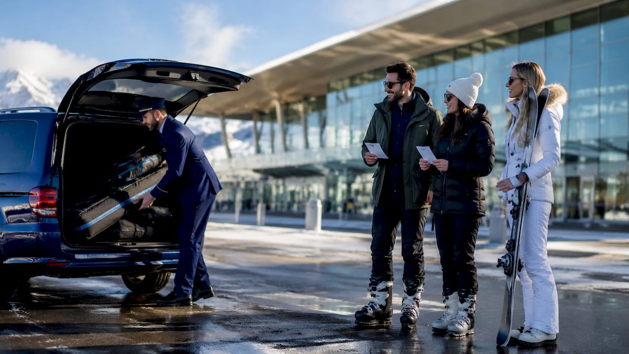 Group loading luggage into private transfer van