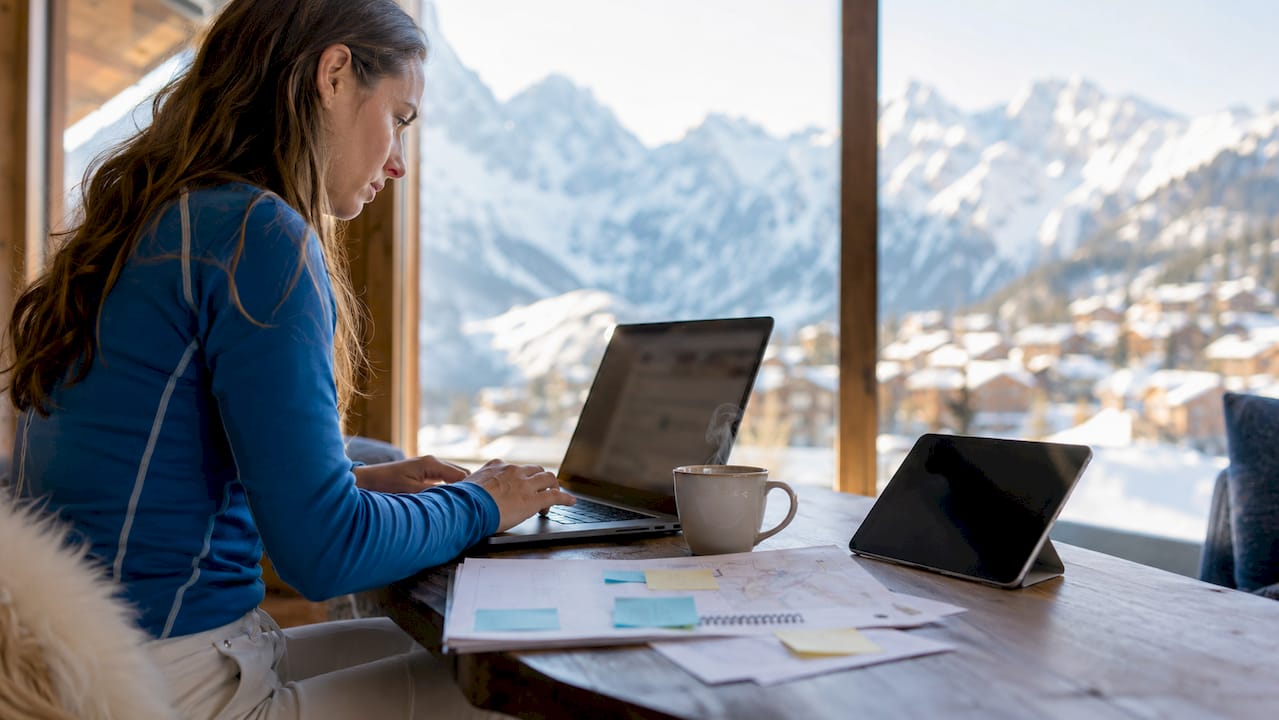 Person booking group transfer on laptop