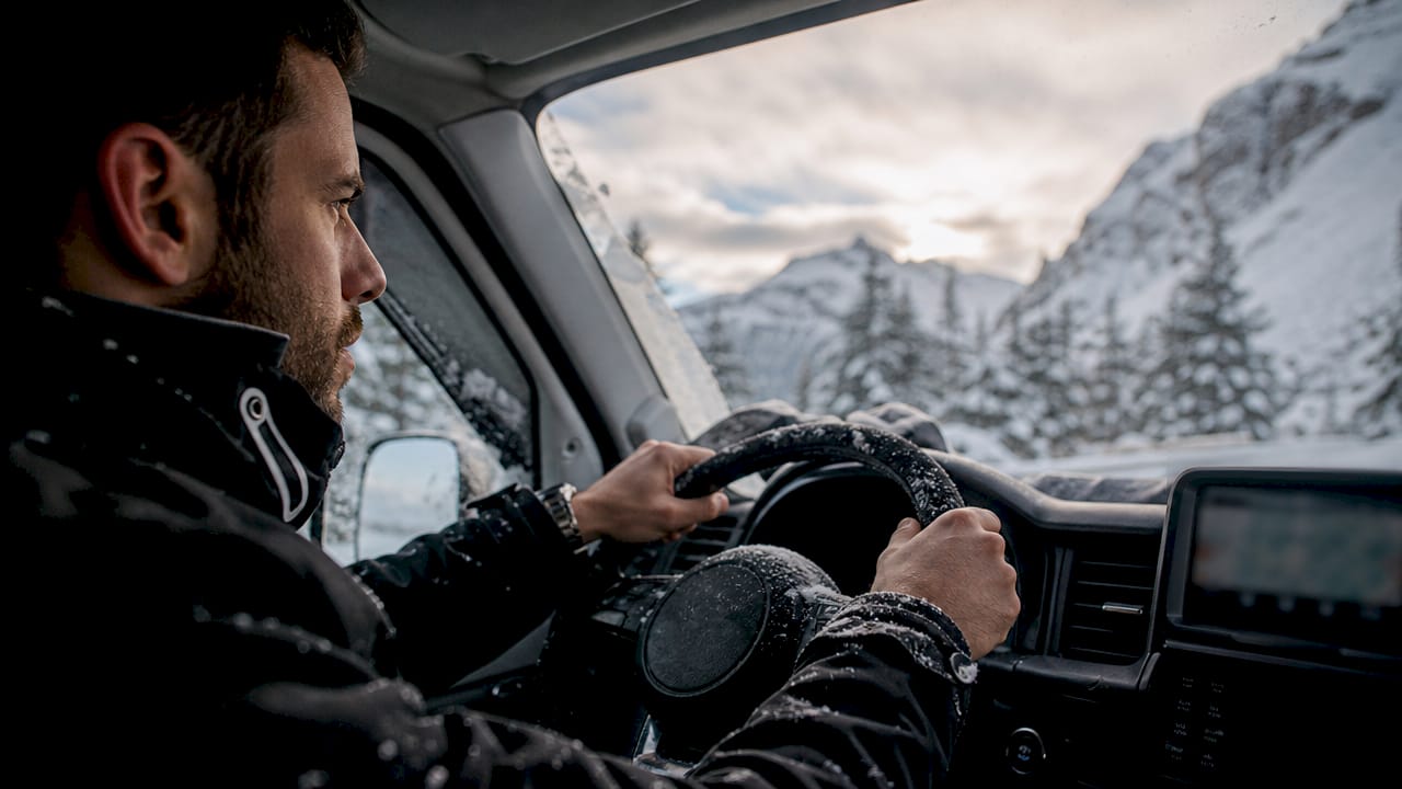 Driver navigating winter roads to Courchevel