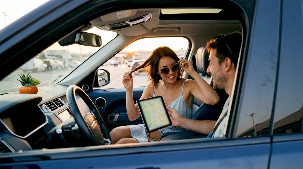 Couple in luxury car at Nice Airport