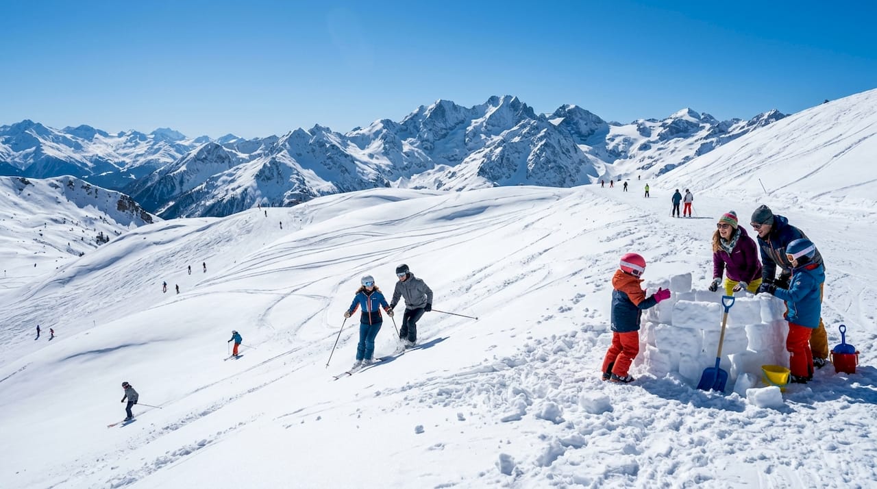 Skiers enjoying panoramic mountain slopes