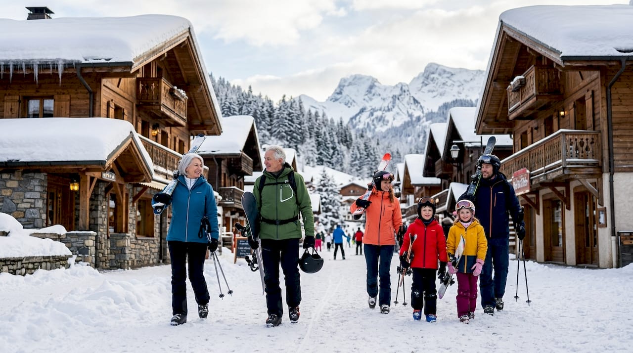 Happy family walking in snowy alpine village
