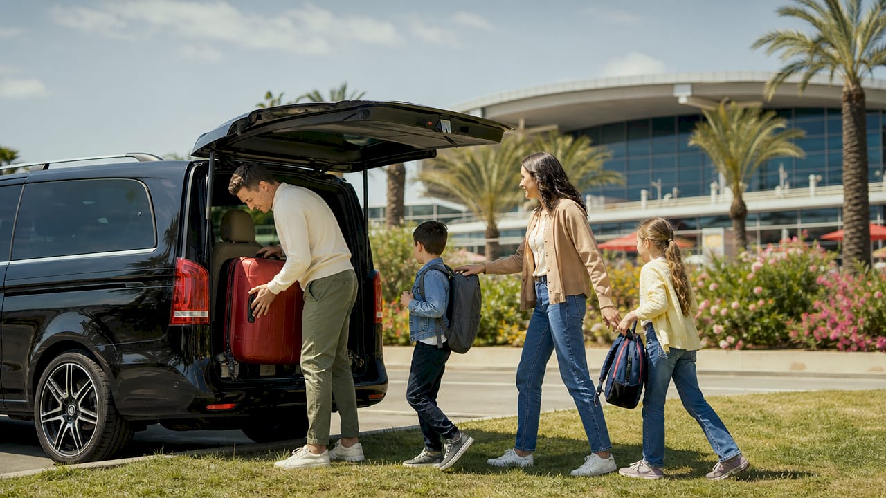 Family loading luggage into minivan at Nice Airport