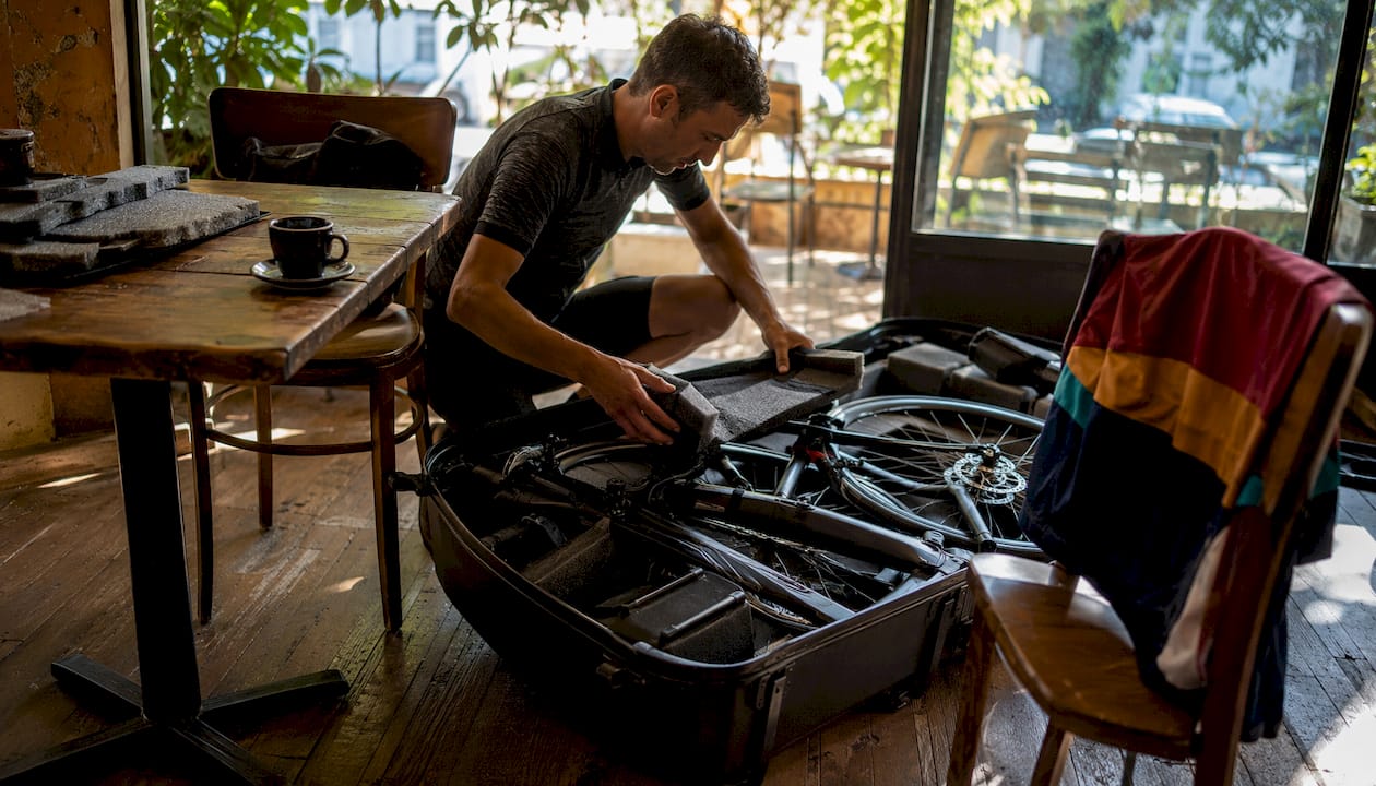 Cyclist packing road bike for airport transfer