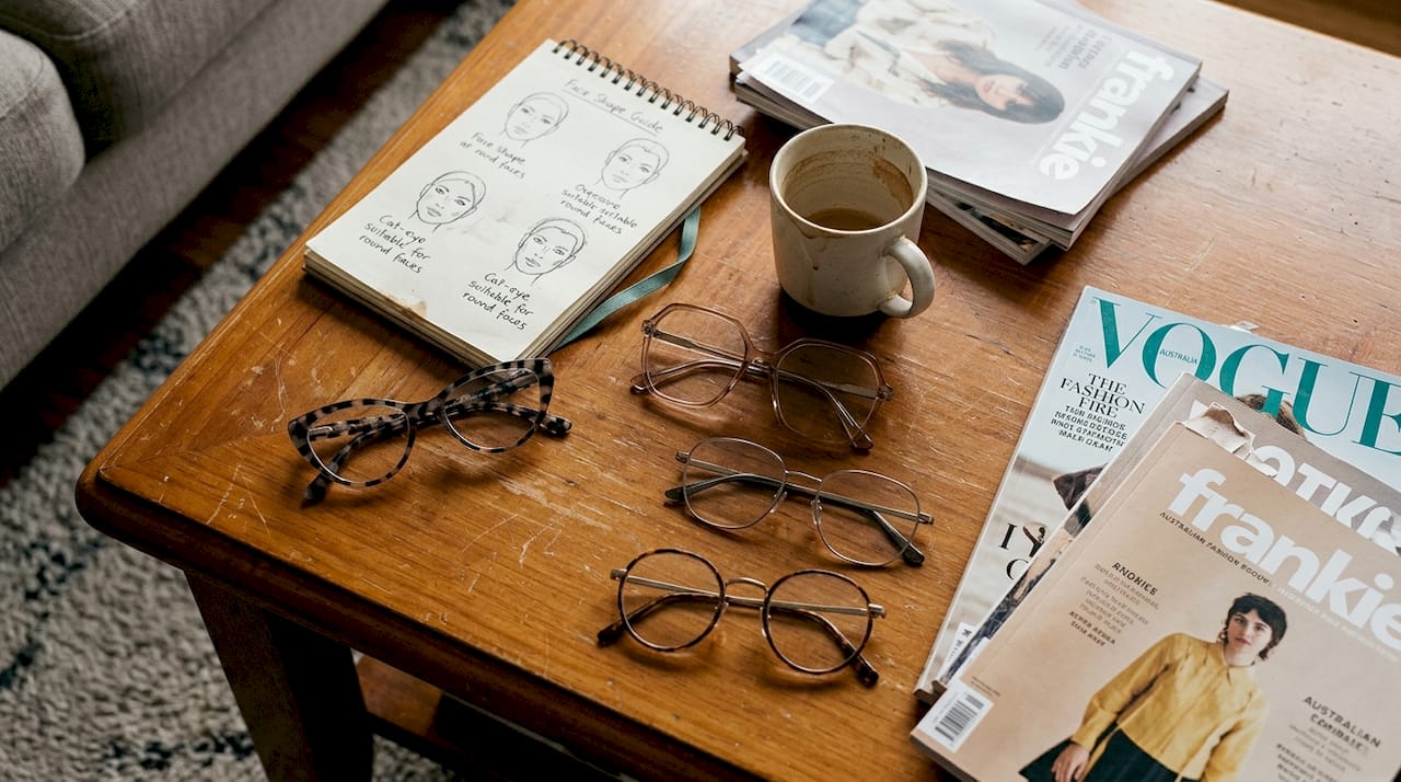 Various trendy eyeglass frames on table