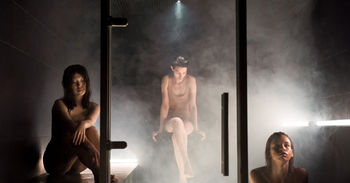 Person sipping water in sauna with hydration reminder on watch