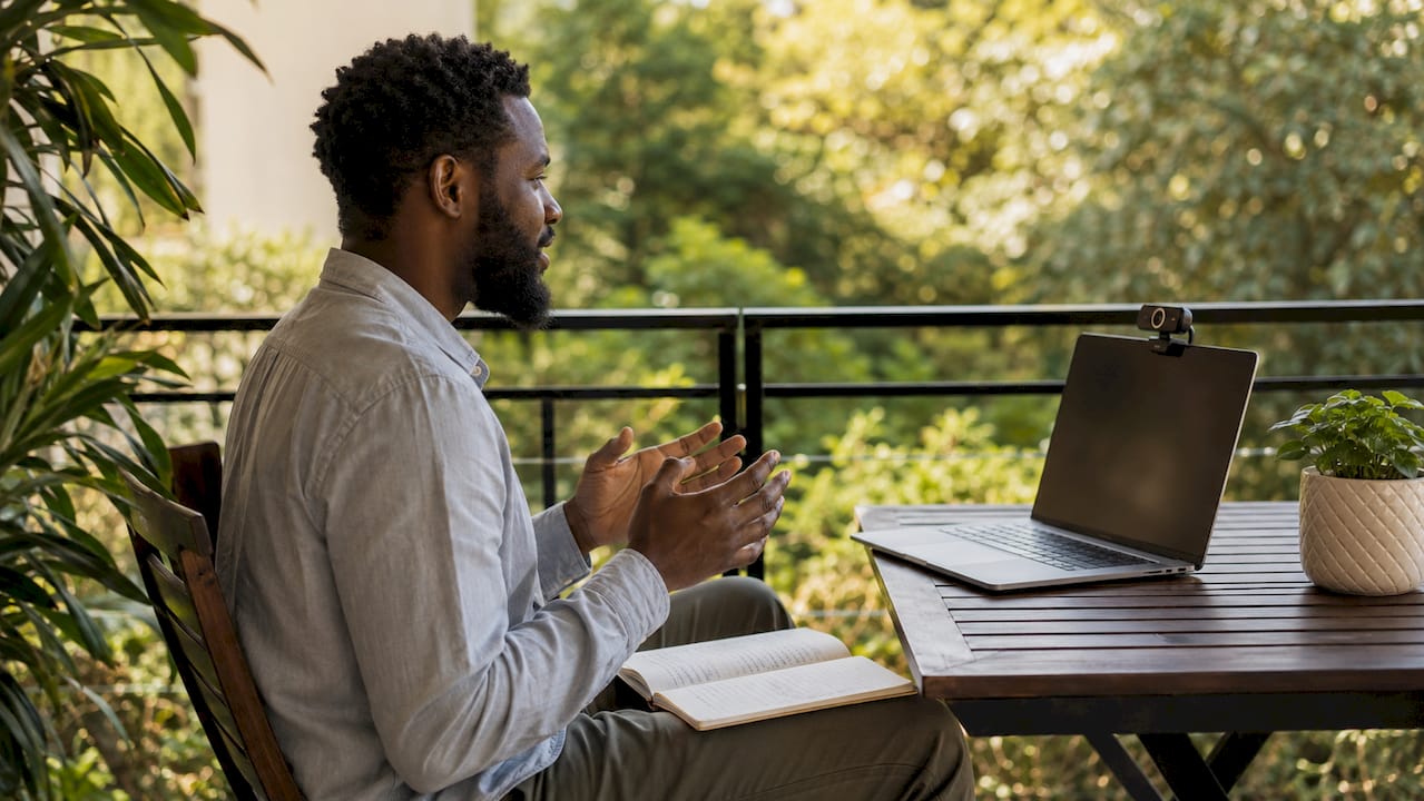 Man recording answers in home office interview