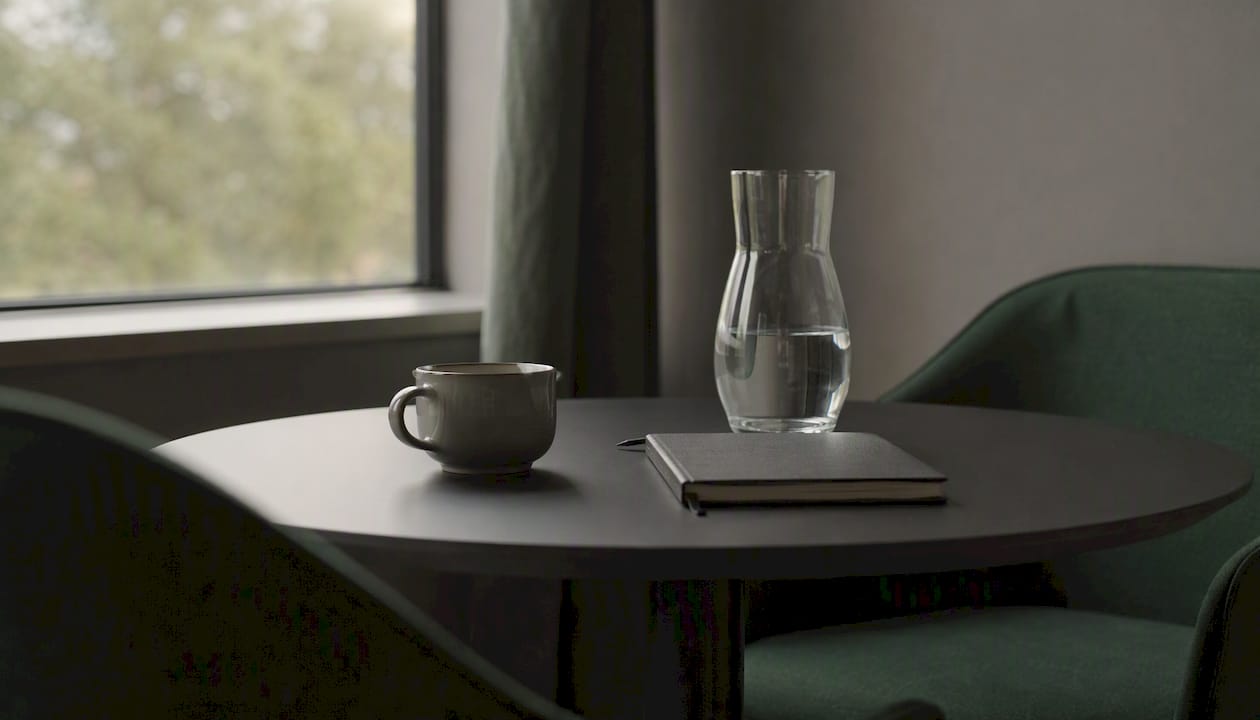 Empty modern office lounge with coffee and notebook