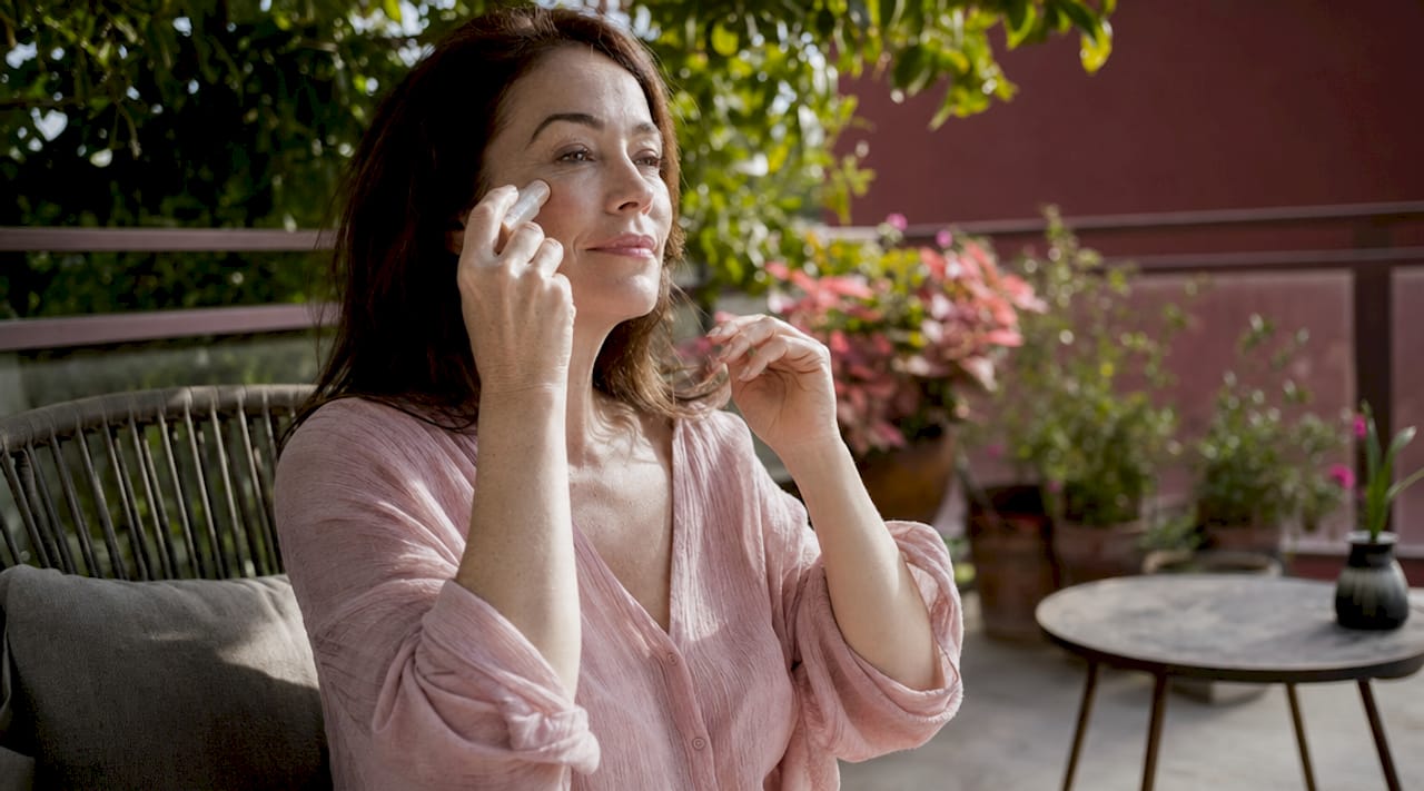 Close-up of hands applying multi-use makeup stick