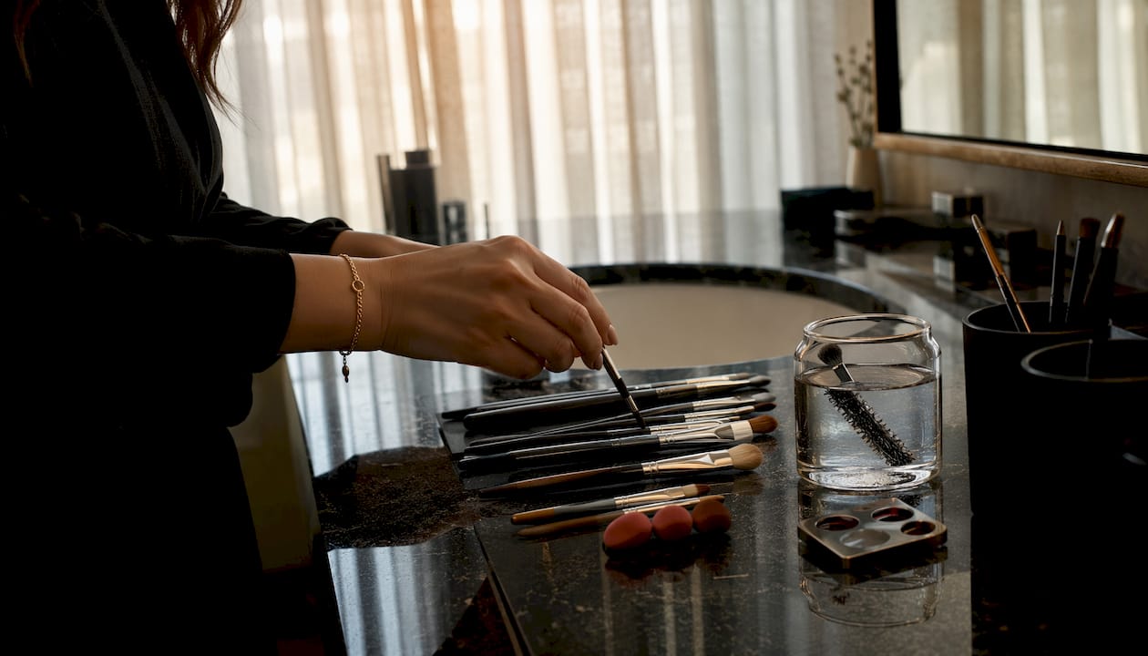 Makeup artist selecting lip brush tools