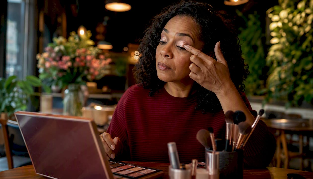 Woman applying shimmer eyeshadow tutorial