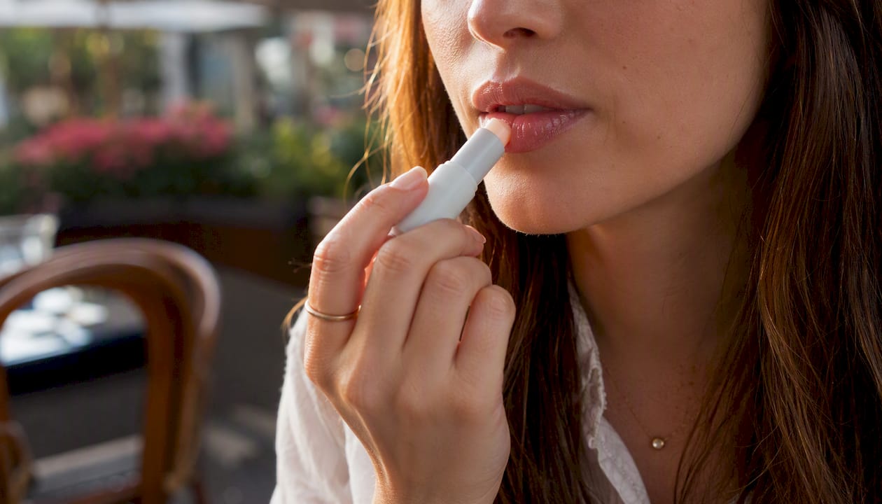 Close-up of lips with cinnamon balm application