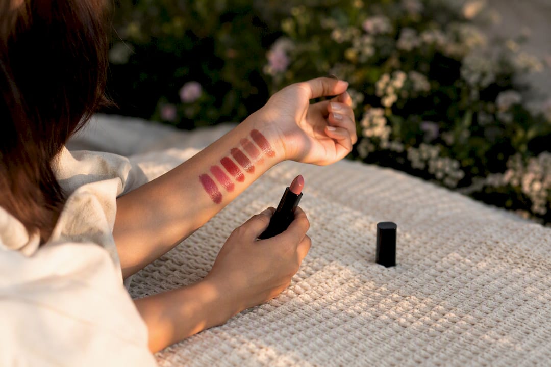 Overhead view of lipstick swatches in natural light