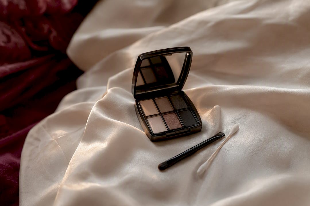 Compact eyeshadow touch-up kit on fabric