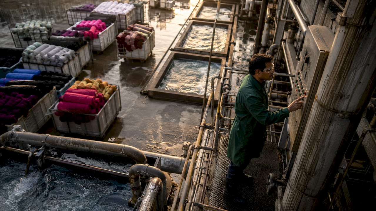 Technician monitoring textile factory water systems