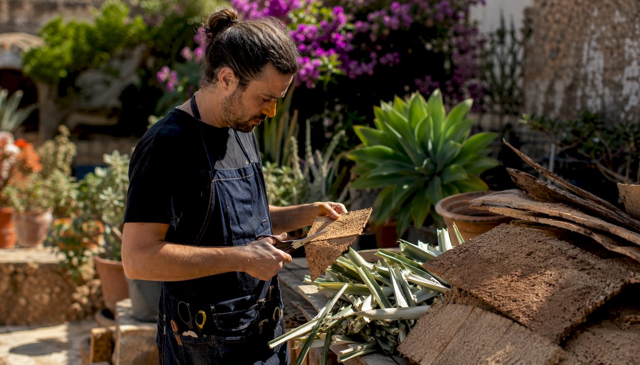 Hands crafting plant-based materials