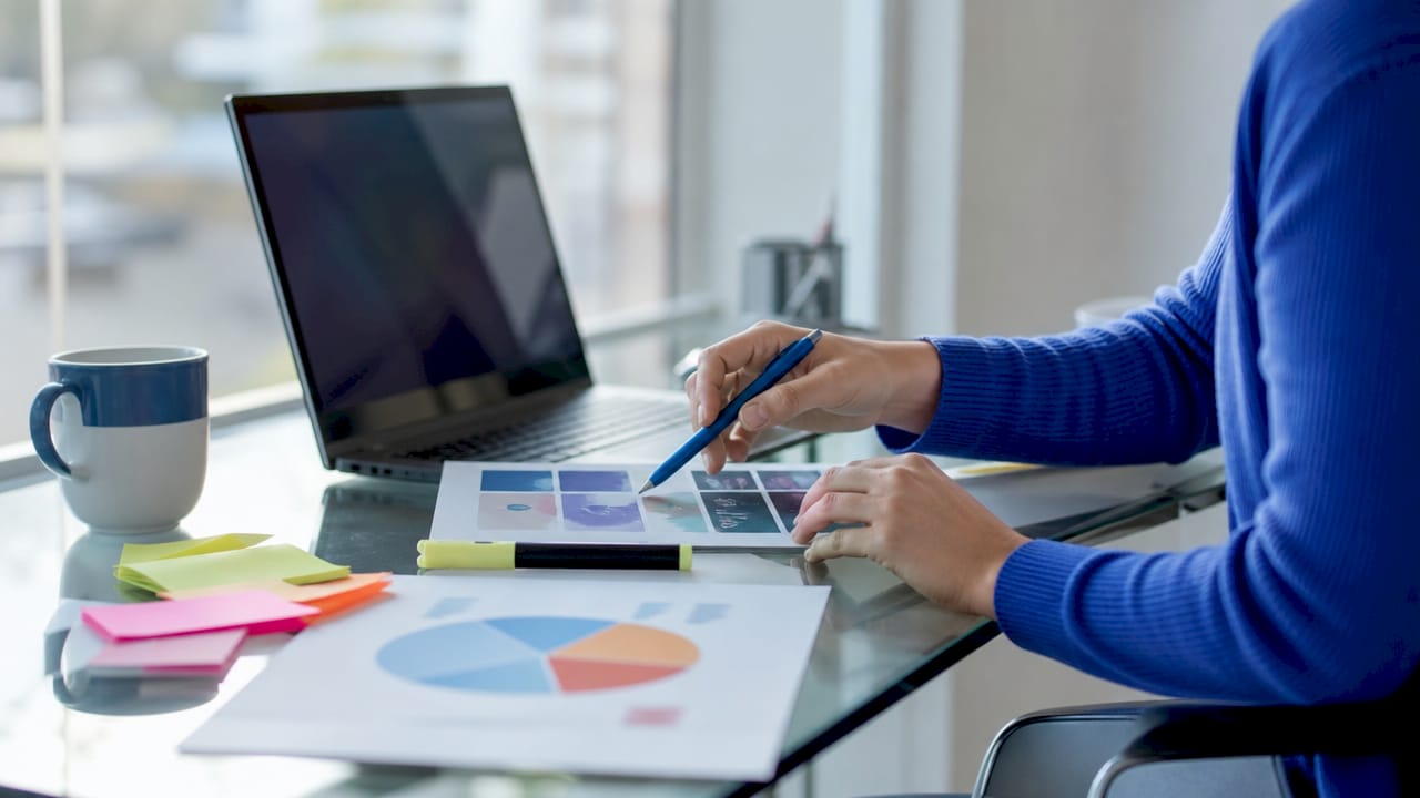 Hands typing on laptop creating LinkedIn single image ads