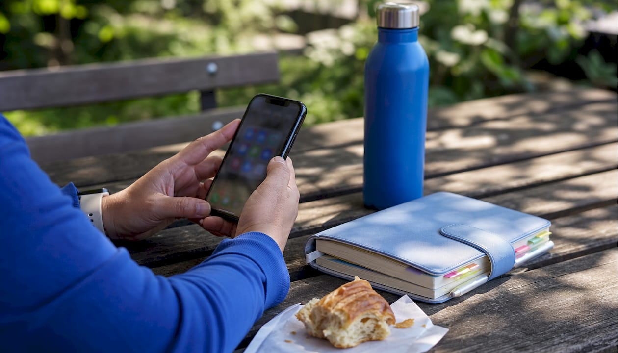 Hands holding phone deciding social media platforms