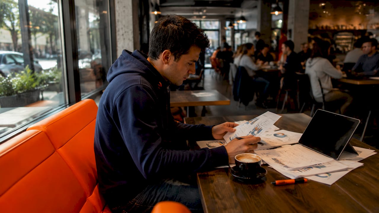 Hands arranging social media marketing planning documents