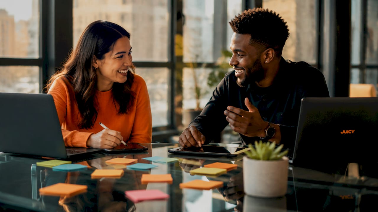 Colleagues discussing social ad campaign in café