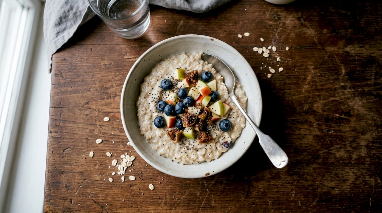 Porridge topped with assorted fruits and seeds