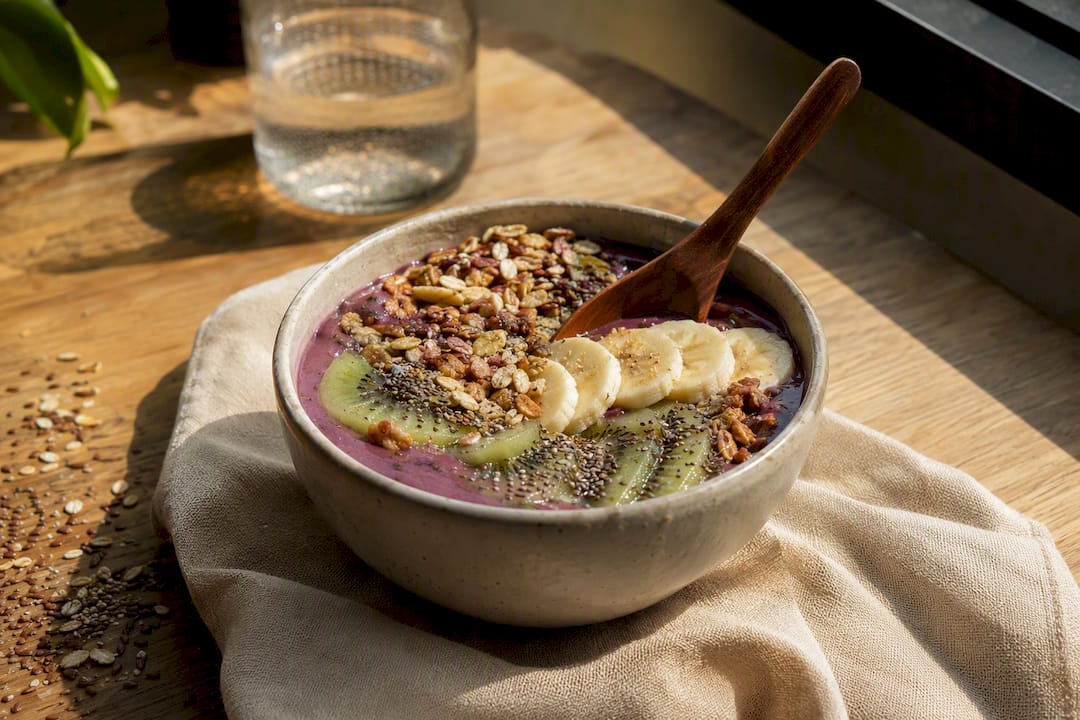Smoothie bowl with granola, seeds and fruit toppings