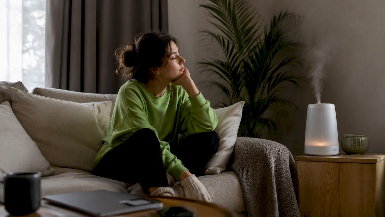 Habitación con una persona descansando, afectada por problemas de humedad en el ambiente.
