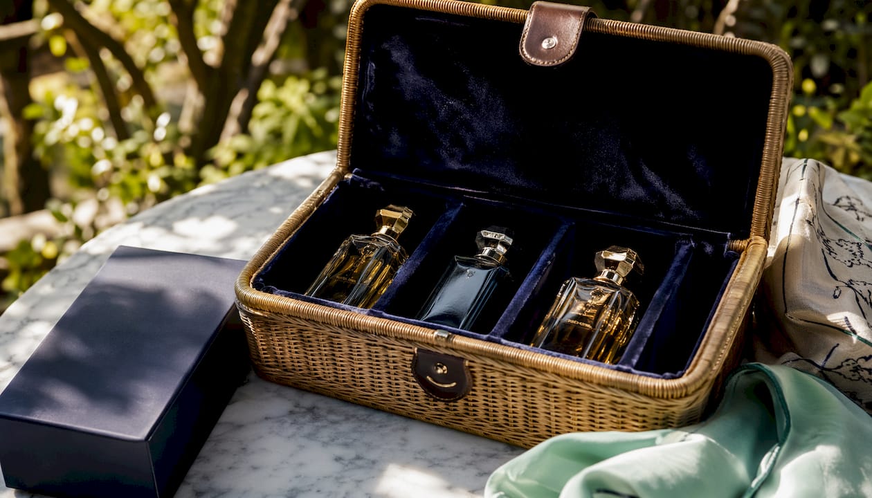 Perfume bottles stored in dark velvet-lined box