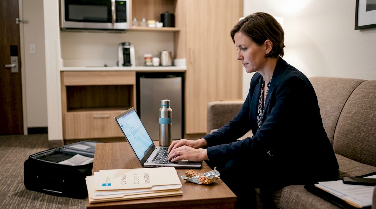 Professional woman working in extended stay suite