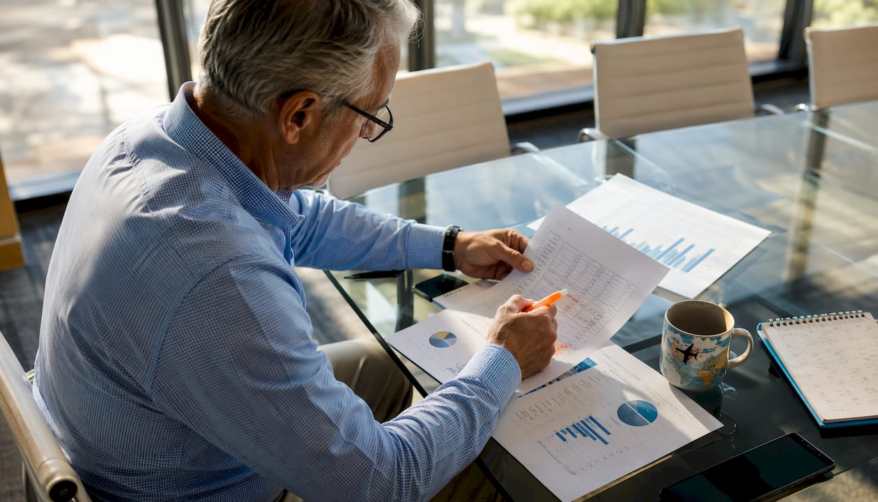 Man reviewing updated per diem rate documents