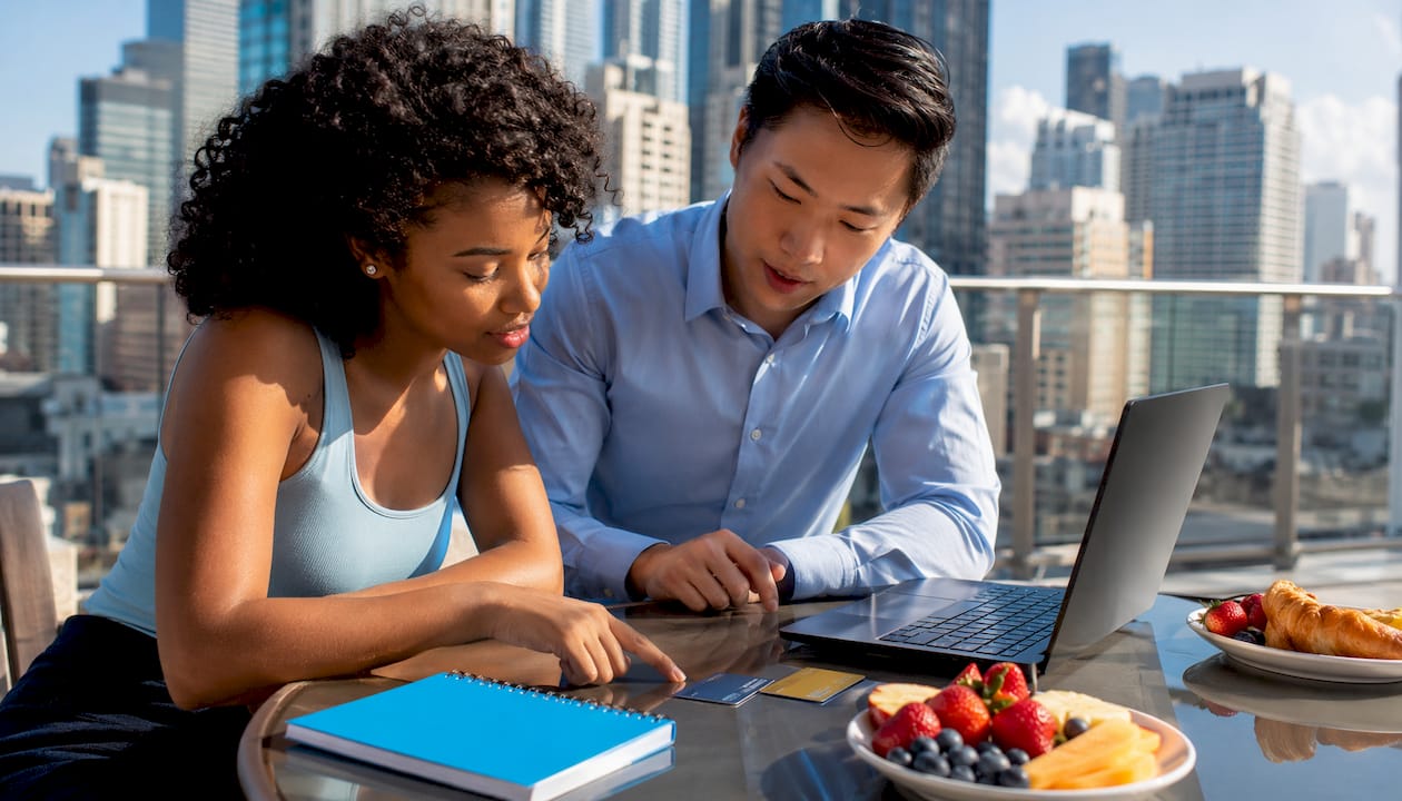 Two professionals comparing cashback and travel rewards cards