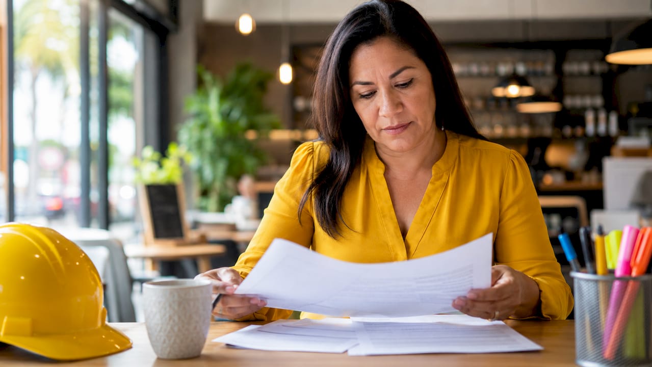 Employee reviewing safety documents in office