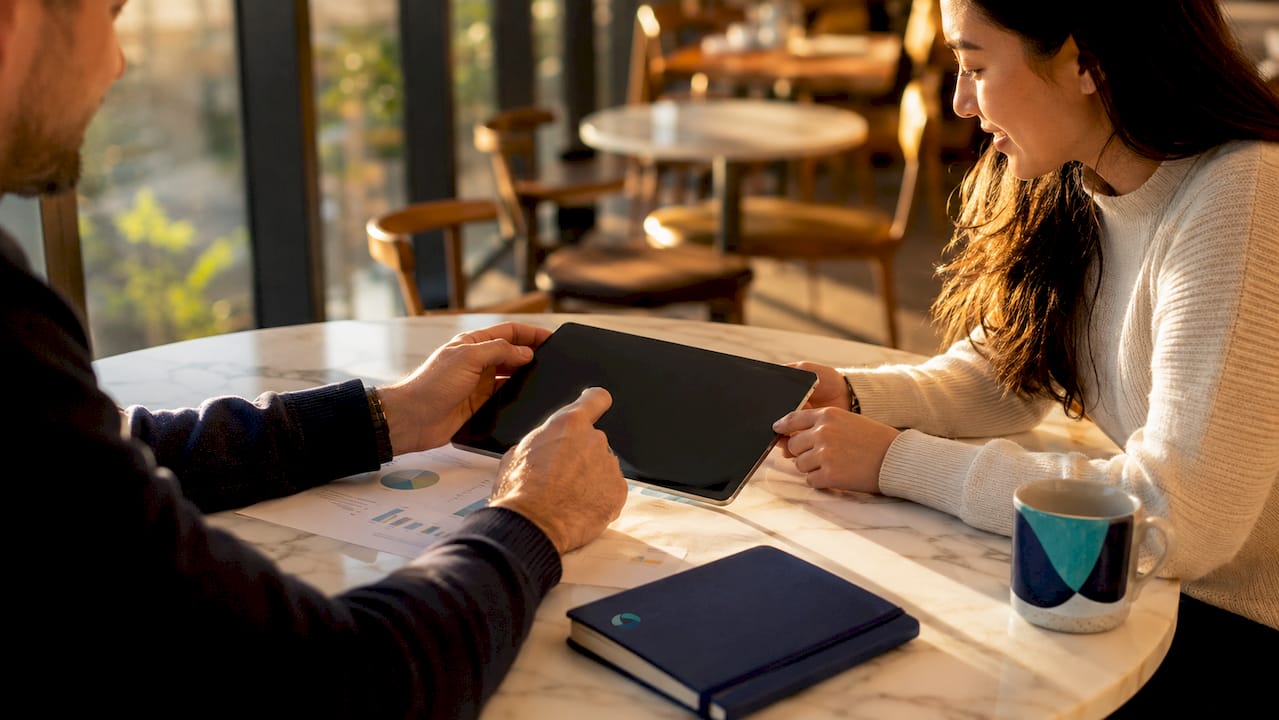 Hands using tablet with return management documents