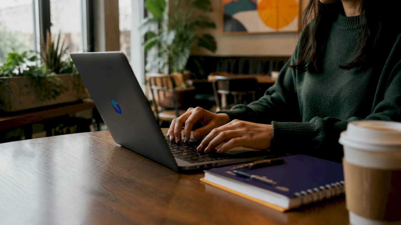 Hands typing laptop for BNPL test transaction