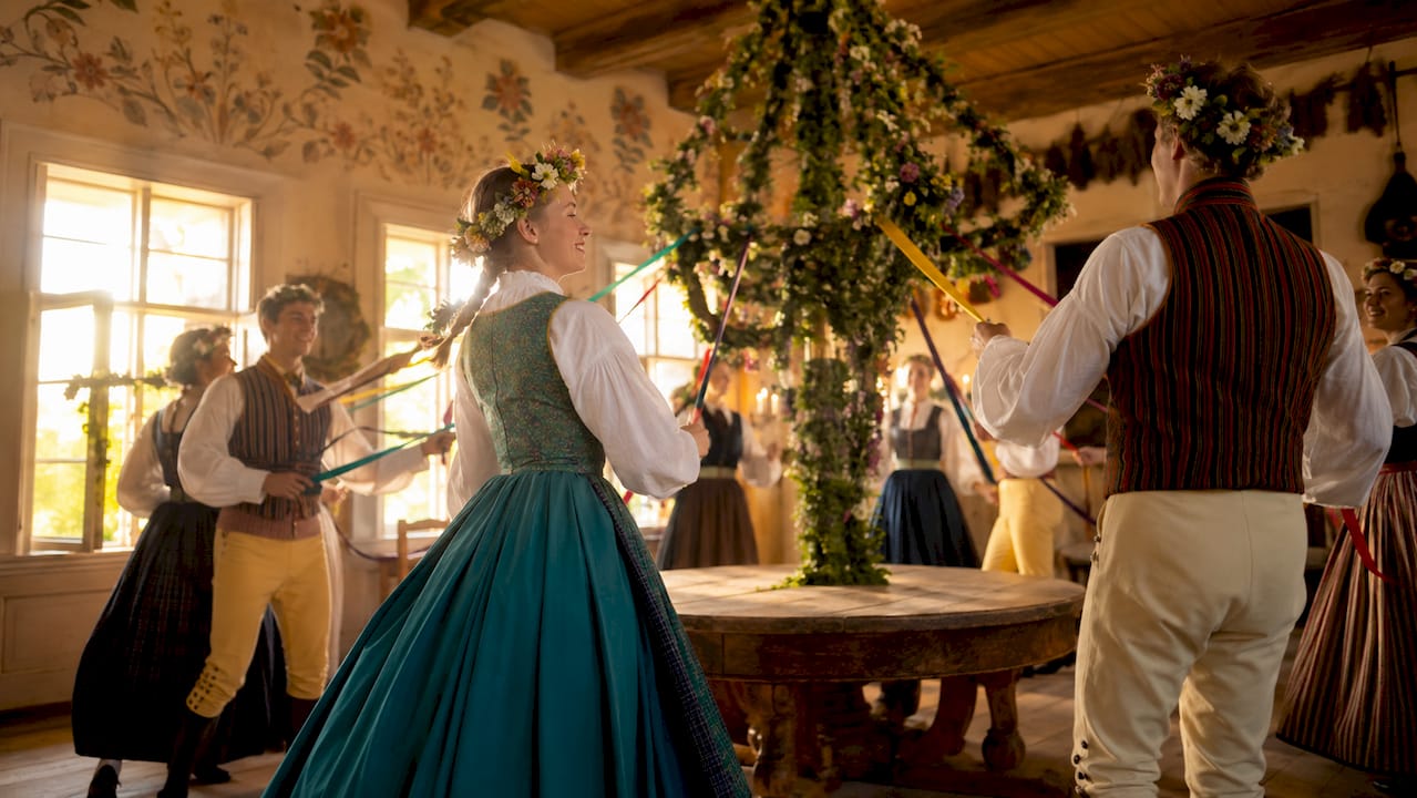 Pleasant Midsummer celebration with bonfire, communal singing, and folk dancers