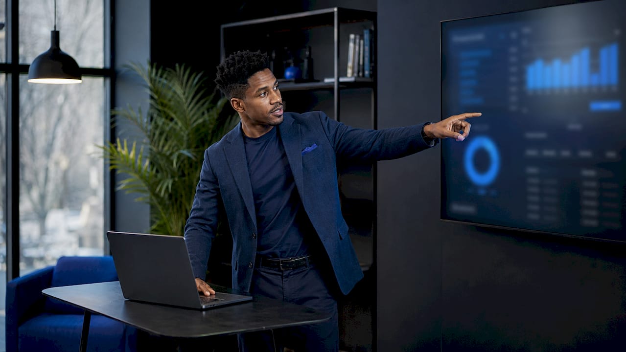 Man explaining real-time analytics in warehouse office