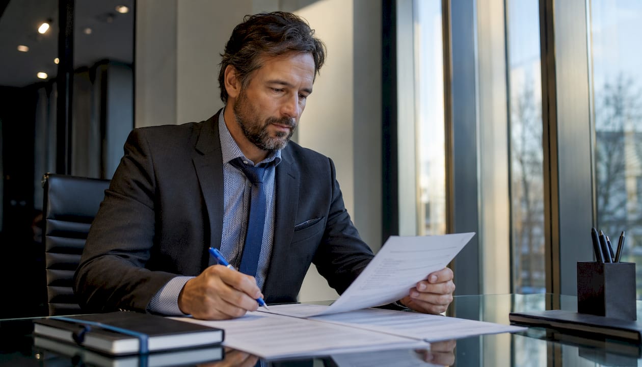 Businessman reviewing bullet point formatted documents
