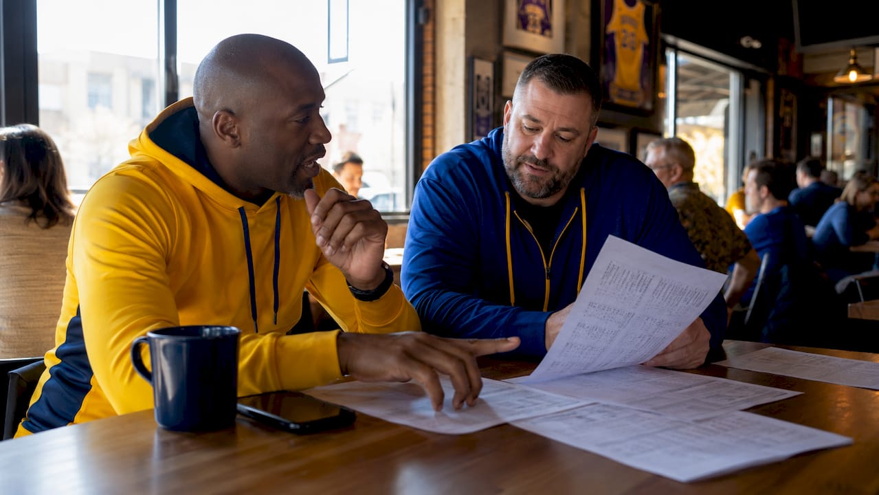 Scout and coach discussing basketball analytics