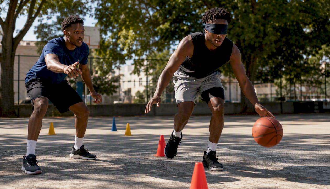 Player verbally guiding blindfolded teammate during dribble relay