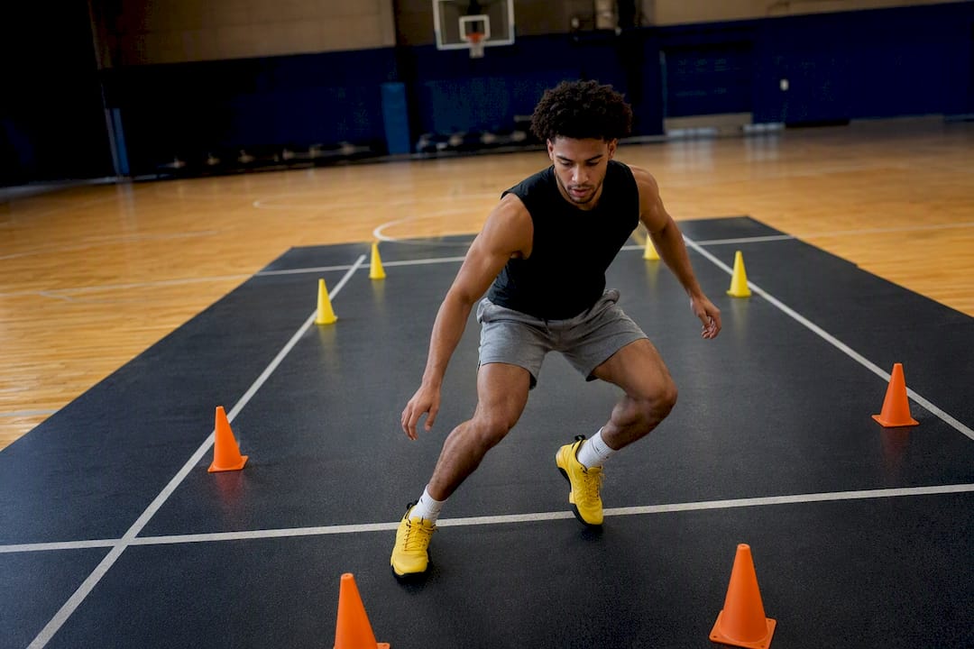 Player performing lateral lane slide drill indoors