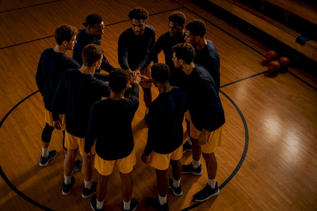 Basketball team performing pregame huddle ritual