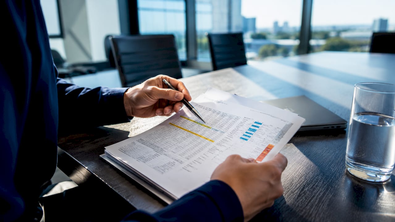 Hands reviewing Manual J load calculation report