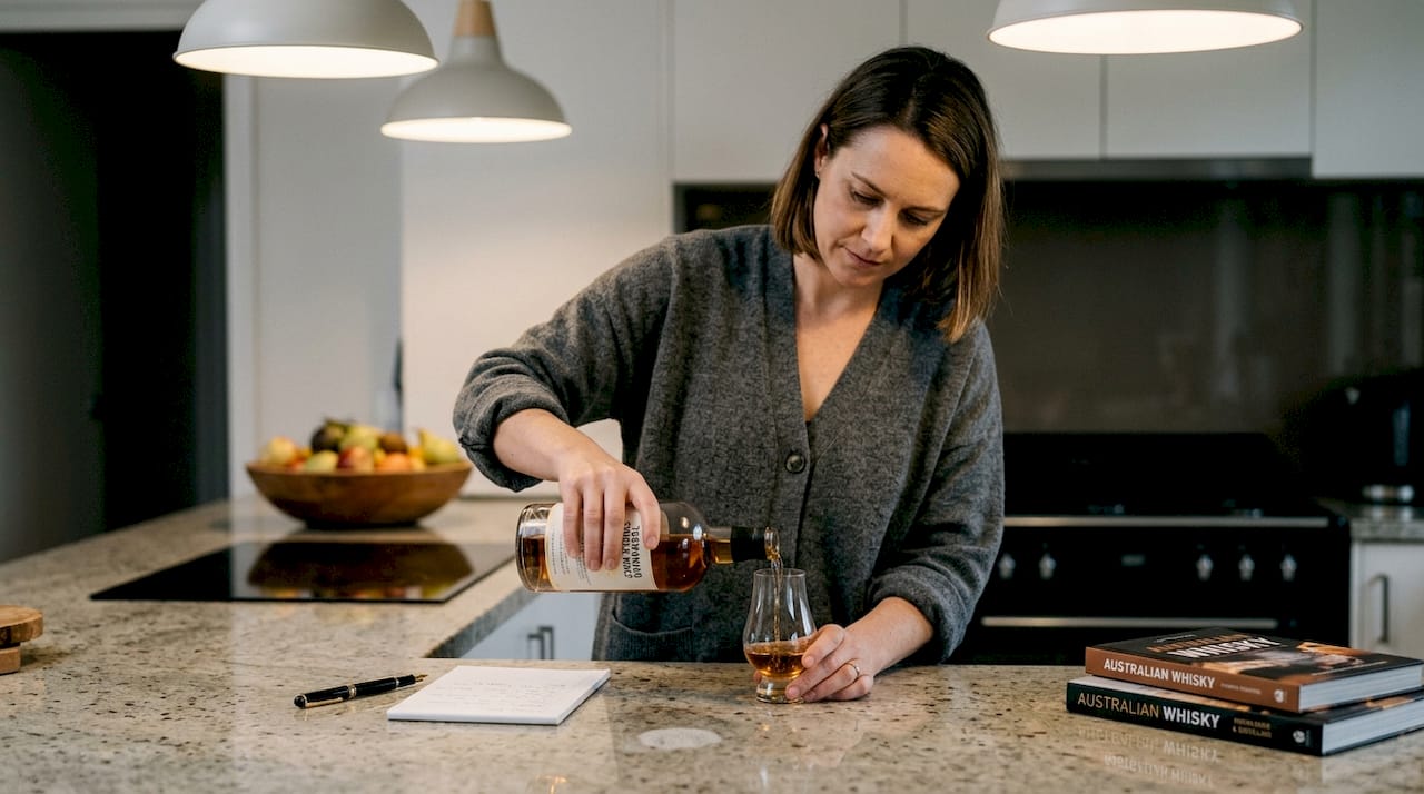 Tasmanian whisky enthusiast pouring tasting glass